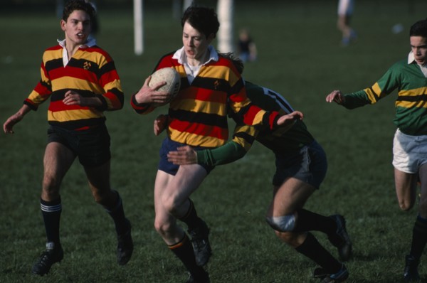 10045937 SPORT Ball Games Rugby Junior boys team  player being tackled by the opposition.