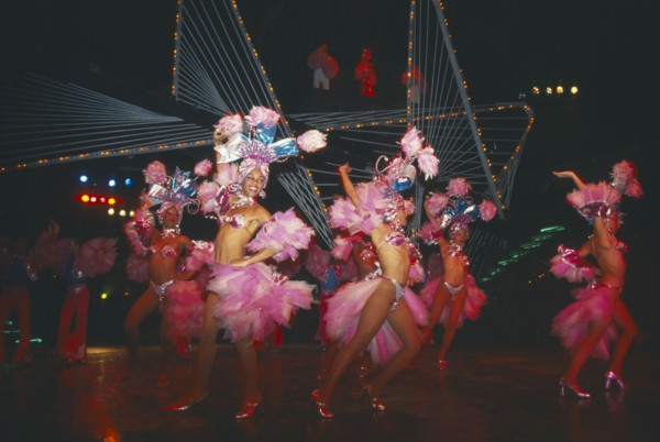 CUBA, Havana Province, Havana, Female Club Tropicana dancers on stage with singers on overhead