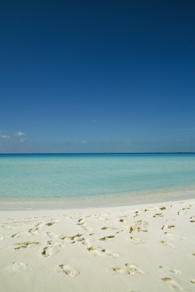 CUBA, Isla De Juventud, Cayo Largo, Playa Serena looking out to sea with footprints in the sand