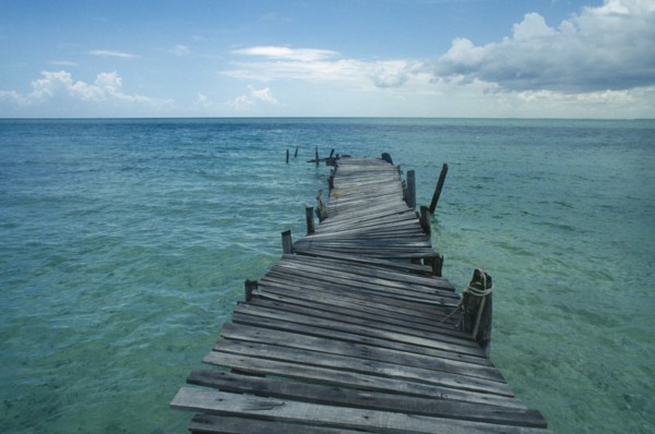 CUBA, Ciego De Avila, Cayo Guillermo, Derelict wooden jetty leading out to sea