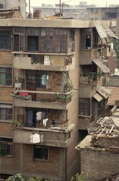 CHINA, Shaanxi, Xian, Housing block with potted plants and drying clothes on the balconies.