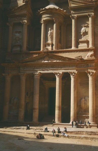 JORDAN, Petra, The Treasury with porticoed entrance carved into rock with camel and people in front
