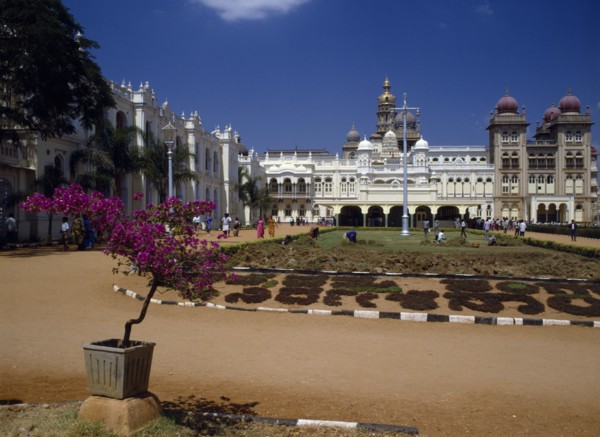 INDIA,  , Mysore, Maharaja’s Palace.  Exterior facade with visitors and people working in grounds.