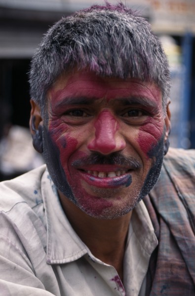 INDIA, Delhi, Head and shoulders portrait of man with face covered in pink and black coloured