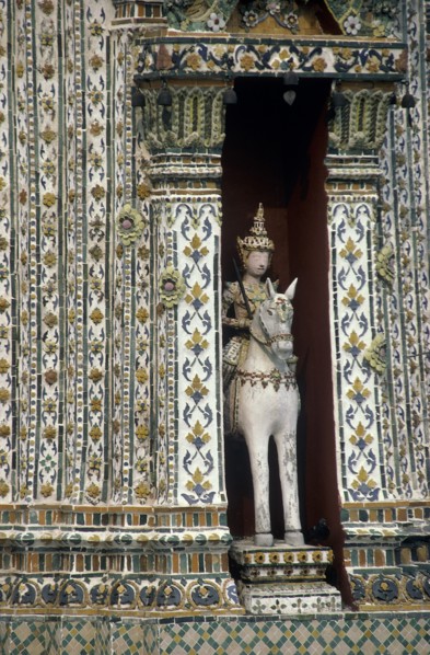 THAILAND, Bangkok, Wat Phra Kaeo close up statue of a horseman set into an alcove of a decorative