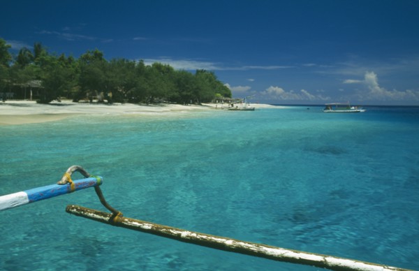 INDONESIA, Lombok, Gili Islands, Gili Trawangan beach seen from approaching outrigger canoe in