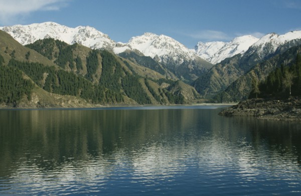 CHINA, Xinjiang , Lake Tianchi, View over the lake toward snow capped mountain peaks