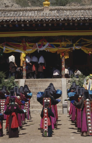 CHINA, Guizhou, Tongren, Tibetan Festival at a temple with rows of girls in traditional costume
