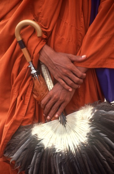 CAMBODIA, Phnom Penh, "Pochentong Airport.  Buddhist monk, detail of hands, robes, umbrella and fan