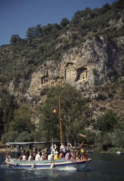 TURKEY, Dalyan, Tourist boat passing rock tombs