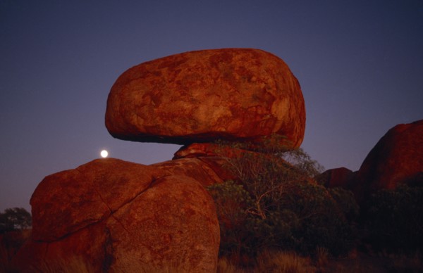AUSTRALIA, Northern Territory, Devils Marbles, View of the large erroded rock spheres at moonrise