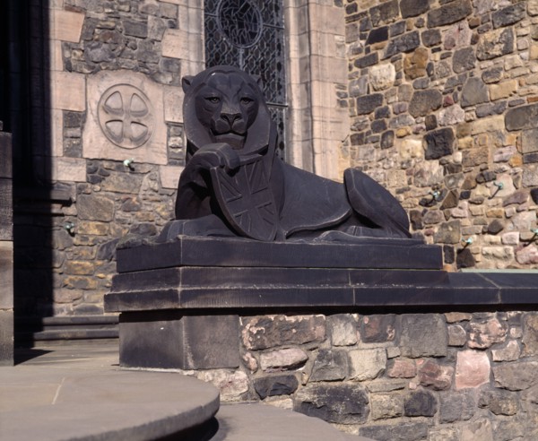 SCOTLAND, Lothian, Edinburgh, Holyrood House. Stone statue of lion holding shield next to steps