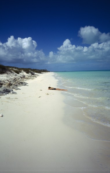 WEST INDIES, Turks And Caicos, Provo, Quiet beach with sunbather lying on the sand by the waters