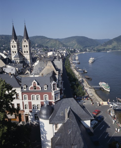 GERMANY, Rhineland, Boppard, Town beside River Rhine. Building with twin towers. Boats moored at