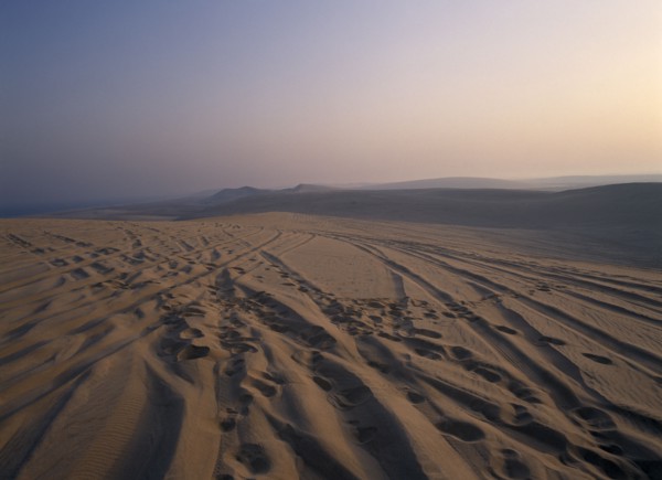 QATAR, South East, Desert, View over sand dunes at sunset near the Sealine Resort.