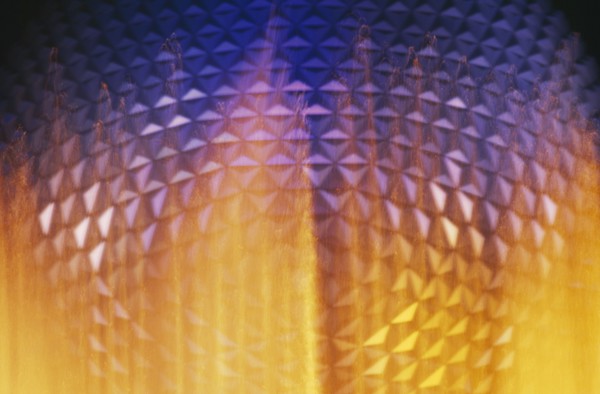 USA, Florida, Orlando, Walt Disney World Epcot Center Spaceship Earth illuminated through fountain