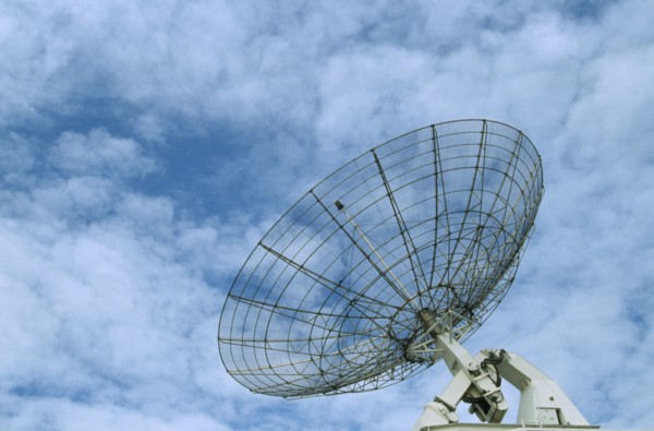 COMMUNICATIONS, Satellite Dish, Satellite dish with a light clouded sky behind