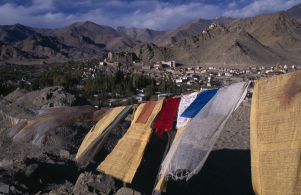 INDIA, Ladakh , Leh , View over Leh Valley and town from hill-top with line of prayer flags flying