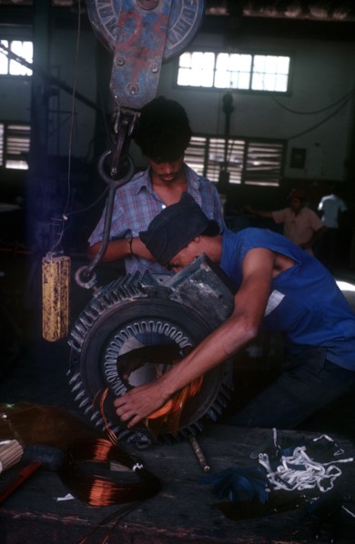 CUBA, Mariel, "Light industry, man in workshop fitting copper wire on to reel"