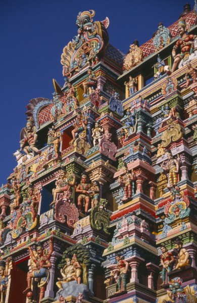 INDIA, Tamil Nadu, Madurai, Sri Meenakshi Temple detail of brightly coloured gopuram exterior wall