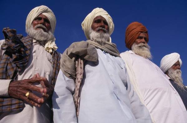 INDIA, Punjab, Amritsar , "Elderly Sikh men, three-quarter view seen from below looking up."