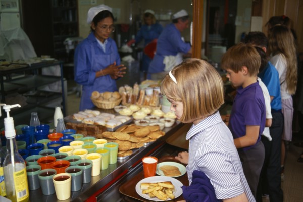 FOOD, Children, School Canteen, Dinner Lady serving lunch to shool kids.