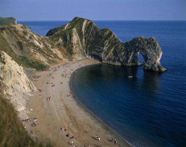 ENGLAND, Dorset, Durdle Door, View over the beach toward eroded coastal arch.