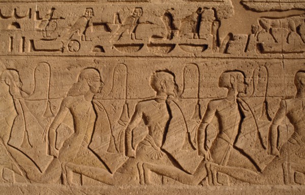 EGYPT, Abu Simbel, Hieroglyphics above relief carving of Nubian slaves