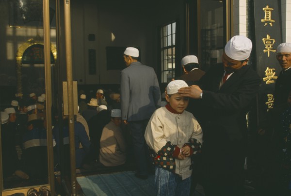 CHINA, Gansu Province, Lanzhou, Family outside mosque.