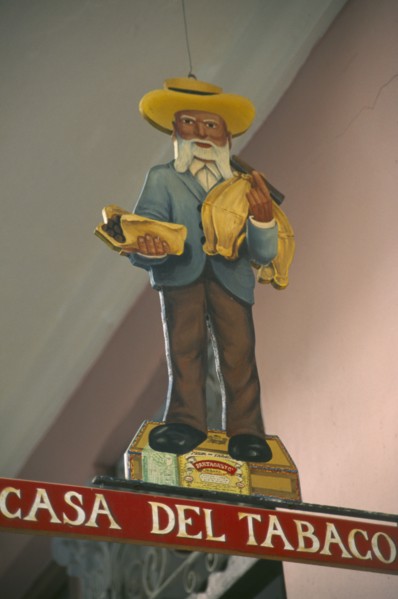 CUBA, Havana Province, Havana, Sign hanging outside cigar shop showing bearded old man in hat