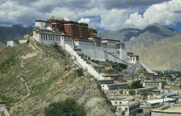 TIBET, Lhasa, Potala Palace, Near view of buildings set on hill in valley surrounded by mountains