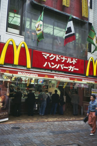 JAPAN, Honshu, Tokyo, McDonalds fast food restaurant with customers and sign above written in