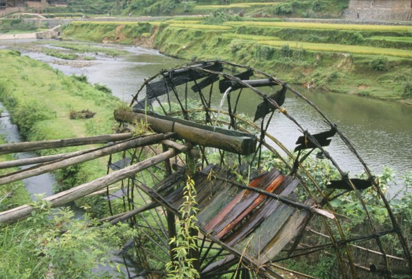 CHINA, Guangxi, Bamboo water wheel on the edge of a river.