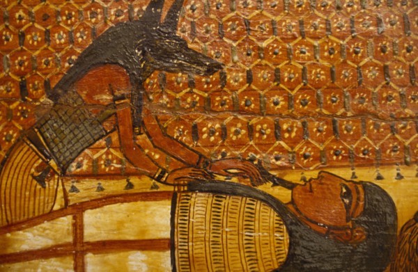 EGYPT, Cairo, Painting on wooden coffin. Jackal Headed God Anubis over reclining figure