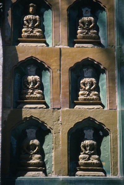 CHINA, Beijing, Summer Palace, Detail of  wall statues with the heads missing from all but one