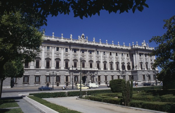 SPAIN, Madrid State, Madrid, The Royal Palace exterior framed by tree branches
