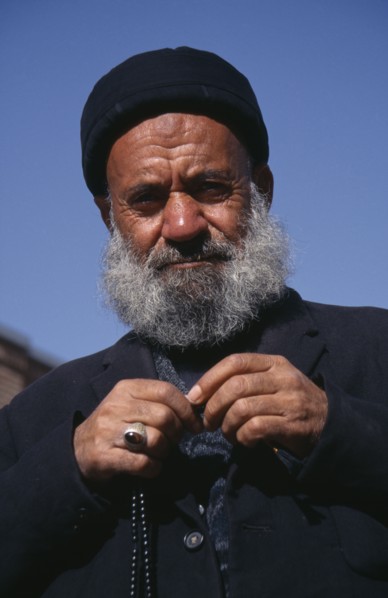 IRAN, Tabriz  , Portrait of an elderly man dressed in black with prayer beads