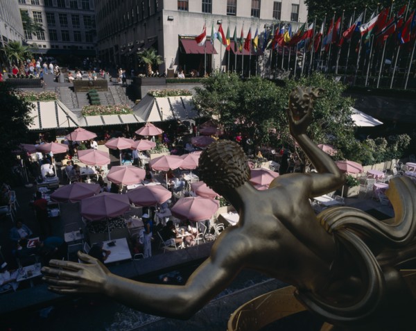 USA , New York State, New York, "Rockefeller Centre, open air cafe with pink umbrellas and gold