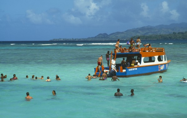WEST INDIES, Tobago, Buccoo Reef, The Nylon Pool with tourists swimming or standing in shallow