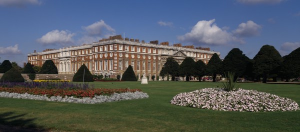 ENGLAND, London, Hampton Court Palace. General view seen across formal gardens