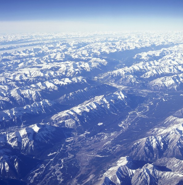 USA, Montana, Glacier National Park, The snow covered Rocky Mountains with a thin layer of cloud