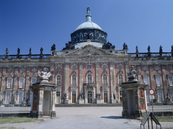 GERMANY, Potsdam, Sanssouci, The New Palace facade and dome seen through the entrance gates
