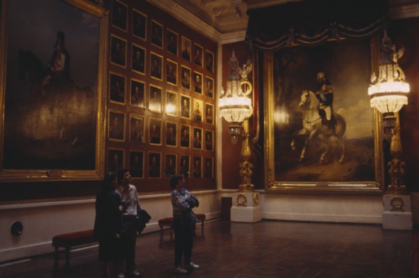 RUSSIA, St Petersburg, "The Hermitage Museum interior, room hung with portaits, three people look