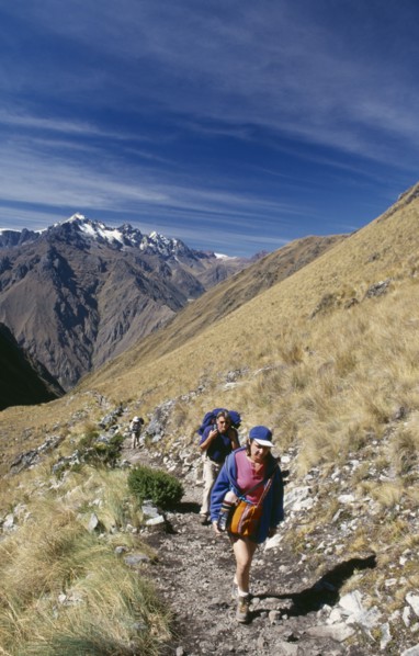 PERU, Cusco Department, The Inca Trail, Treckers with back packs walking up Dead Woman´s Pass.