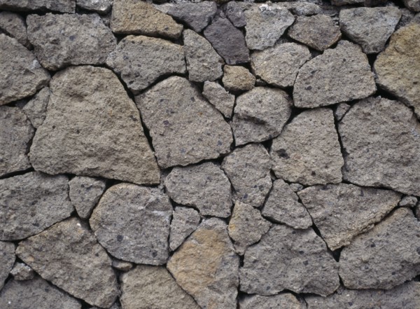 INDONESIA, Bali, Lovina, Detail of dry stone wall at Kalibukbuk