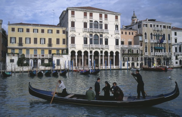 ITALY, Veneto, Venice, A Traghetti gondola taxi with passengers on the Grand Canal.