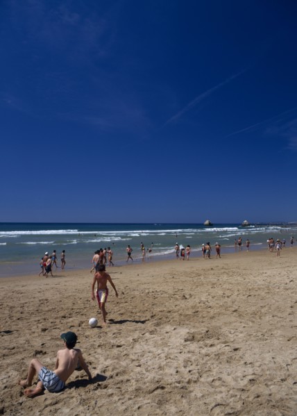 PORTUGAL, Algarve, Praia da Rocha, View along beach with children playing beach soccer