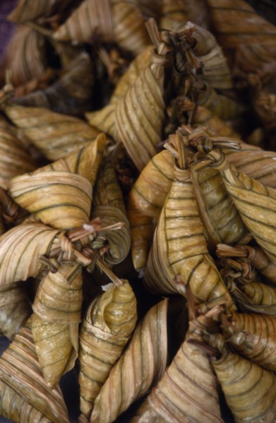 MALAYSIA, Kedah, Langkawi, Pulut a coconut rice dish wrapped in banana leaves on a stall at the
