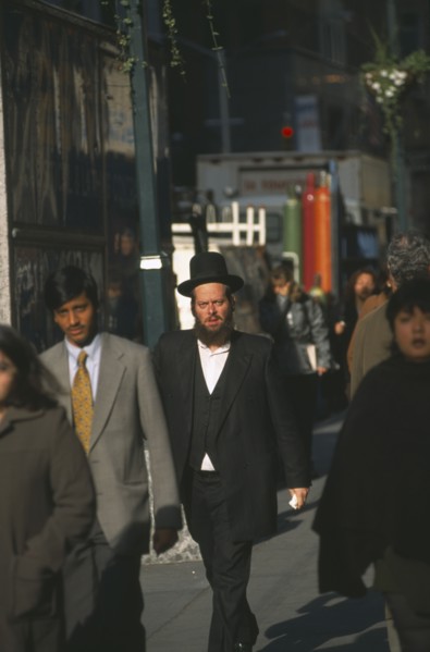 USA, New York State, New York, Orthodox Jewish man walking among other people on 47th Street.