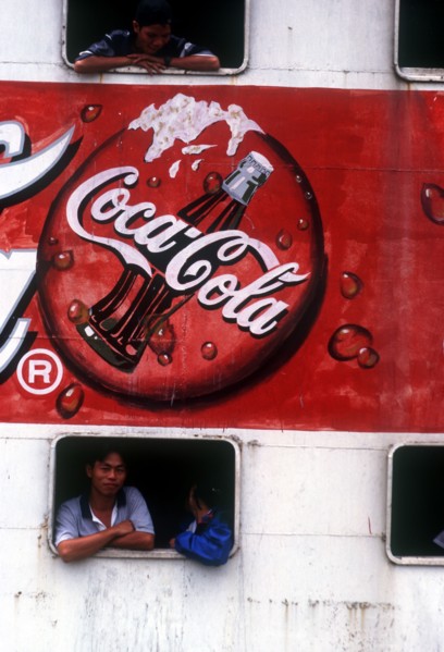 VIETNAM, Mekong Delta, Vinh Long, "Advertisment for Coca Cola on the side of a ferry, passengers at